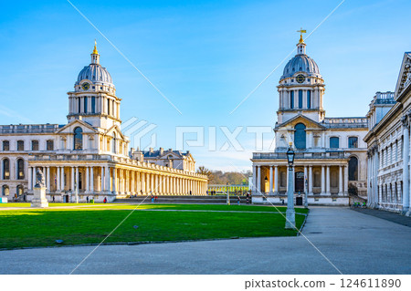 Historical architecture at Greenwich Campus showcases stunning designs amidst green lawns. Visitors enjoy the landscape, highlighting London's rich heritage and educational environment. Historical architecture at Greenwich Campus showcases stunning designs amidst green lawns. Visitors enjoy the landscape, highlighting London's rich heritage and educational environment. 124611890
