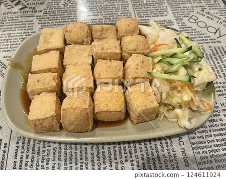 Photographing a freshly fried stinky tofu in a restaurant Photographing a freshly fried stinky tofu in a restaurant 124611924