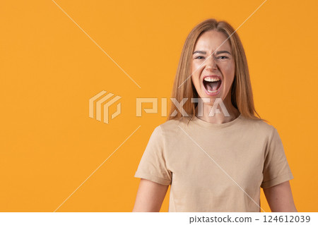 Joyful Woman Shouting on Orange Background 124612039