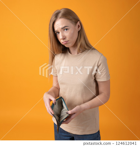 Young Woman Holding an Empty Wallet Young Woman Holding an Empty Wallet 124612041