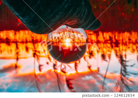 Holding a Crystal Ball upside down Holding a Crystal Ball upside down 124612654