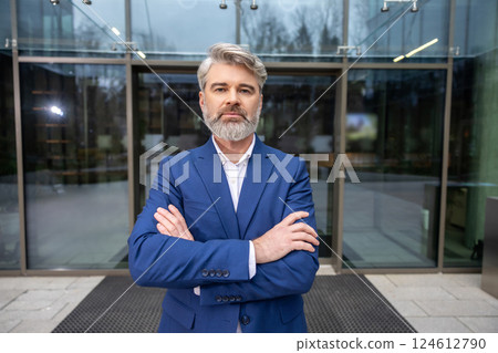 Mature confident businessman in blue suit looking determined 124612790