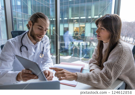 Male physician in lab using touchscreen tablet for medical consultation 124612858