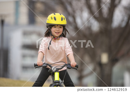 Girl riding a bicycle in the park 124612919