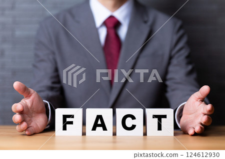 FACT block and middle-aged male businessman in a suit 124612930