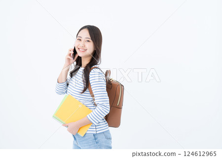 A young female college student making a phone call A young female college student making a phone call 124612965