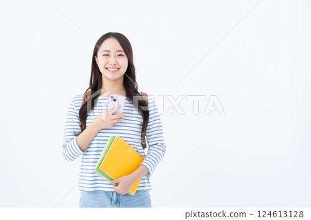 Female college student using a smartphone Female college student using a smartphone 124613128