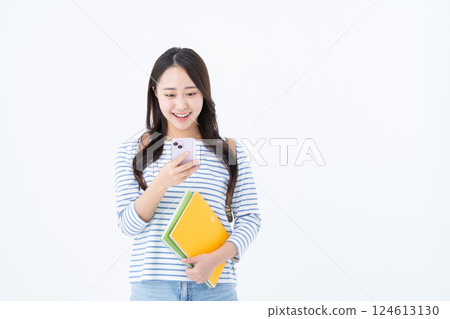 Female college student using a smartphone Female college student using a smartphone 124613130