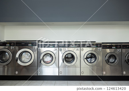 Rows of industrial laundry machines in the laundromat 124613420