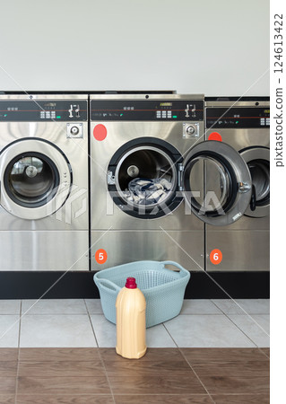 Laundry service shop with automatic washer and dryer Laundry service shop with automatic washer and dryer 124613422