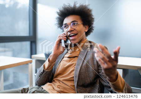 Man using wireless device to manage information and plan his work in the modern office 124613476