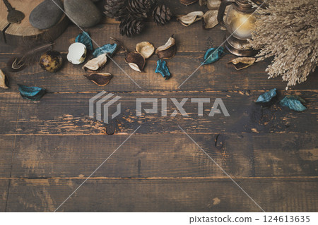 Witchcraft atmospheric set. Dry herbs, blue flower petals, stones, small lantern, old key, birds feather on rude wooden surface, copy space. 124613635