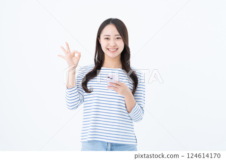 A young woman using a smartphone 124614170