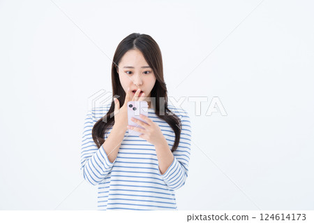 A young woman using a smartphone A young woman using a smartphone 124614173