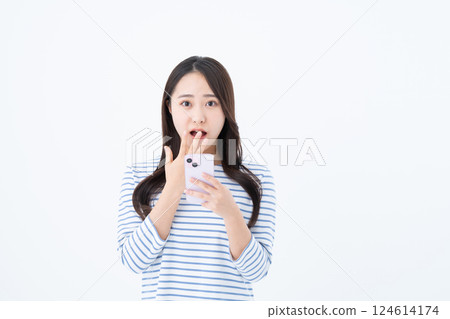 A young woman using a smartphone A young woman using a smartphone 124614174