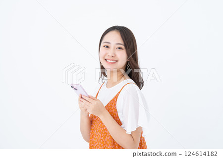 A young woman using a smartphone A young woman using a smartphone 124614182