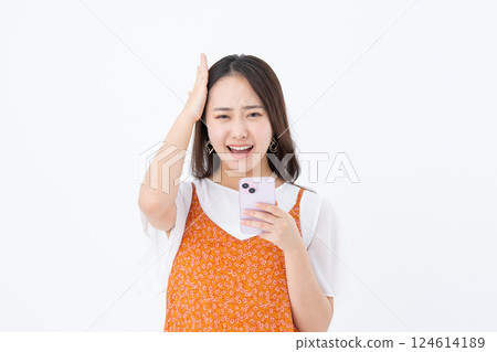 A young woman using a smartphone 124614189