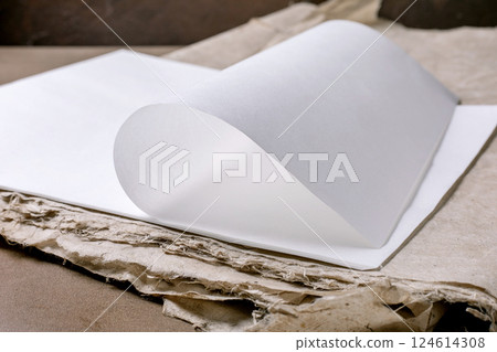 Elegant White Paper Curled On Cardboard 124614308