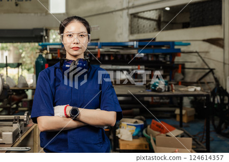 Portrait engineer women working in Lathe shop with metal machinery lathe milling machine, confident smart looking camera. Portrait engineer women working in Lathe shop with metal machinery lathe milling machine, confident smart looking camera. 124614357