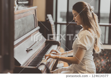 Musician pianist playing music with old wooden piano brown vintage color tone. 124614377