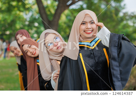 Group of Asian Muslim women Happy congratulation university outdoors. Arab hijab girls friend in bachelor college graduation school uniform. Group of Asian Muslim women Happy congratulation university outdoors. Arab hijab girls friend in bachelor college graduation school uniform. 124614387