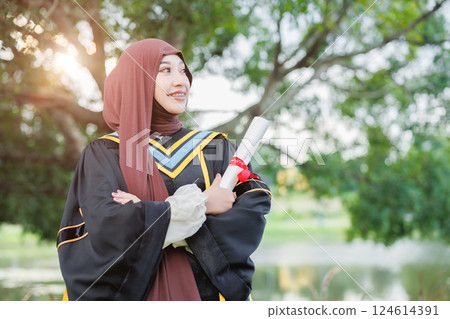 Asian Muslim women Happy congratulation university outdoors. Arab hijab girl in bachelor college graduation school uniform. Asian Muslim women Happy congratulation university outdoors. Arab hijab girl in bachelor college graduation school uniform. 124614391