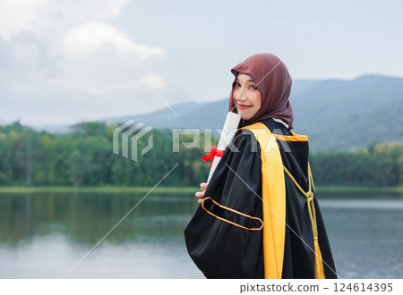 Asian Muslim women Happy congratulation university outdoors. Arab hijab girl in bachelor college graduation school uniform. Asian Muslim women Happy congratulation university outdoors. Arab hijab girl in bachelor college graduation school uniform. 124614395