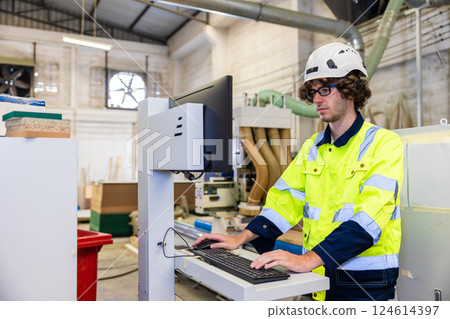 Professional technician engineer male staff worker control operate wood CNC machine 124614397