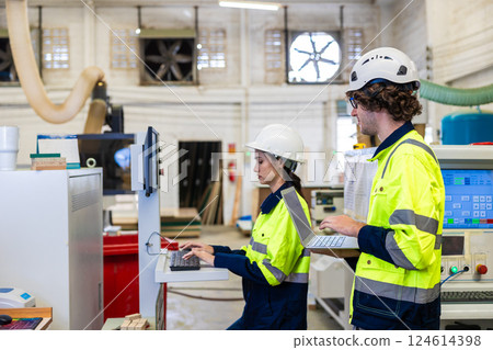 Professional technician engineer team staff worker control operate wood CNC machine together Professional technician engineer team staff worker control operate wood CNC machine together 124614398