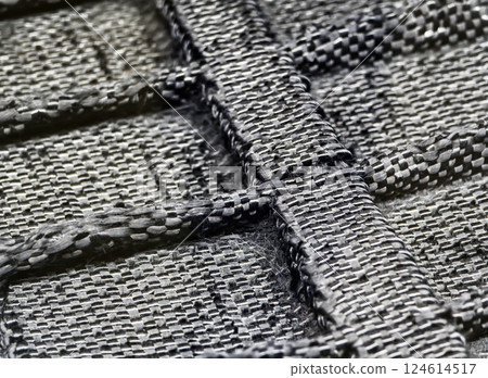 Close-up of a woven carbon fiber texture showcasing intricate patterns and strong construction ideal for various applications Close-up of a woven carbon fiber texture showcasing intricate patterns and strong construction ideal for various applications 124614517