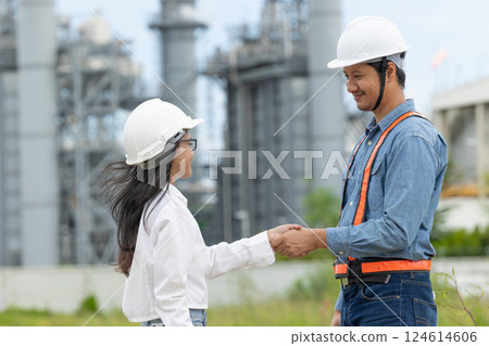 Professional Petroleum Refinery engineer team hand shaking together dealing oil gas building project Professional Petroleum Refinery engineer team hand shaking together dealing oil gas building project 124614606