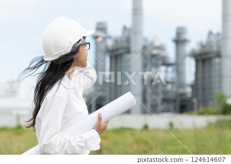 Professional smart vision young engineer women standing at refinery power plant building floor plan Professional smart vision young engineer women standing at refinery power plant building floor plan 124614607
