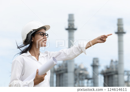 Professional smart vision young engineer women standing at refinery power plant building floor plan Professional smart vision young engineer women standing at refinery power plant building floor plan 124614611