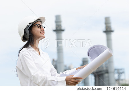 Professional smart vision young engineer women standing at refinery power plant building floor plan 124614614
