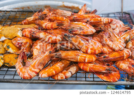 Grilled shrimps at Asian night market in close-up. Traditional street sea food hot prawns in Asia in Vietnam Grilled shrimps at Asian night market in close-up. Traditional street sea food hot prawns in Asia in Vietnam 124614795