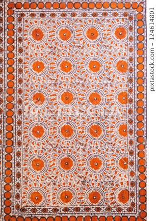 traditional Uzbek geometric pattern on ancient vintage carpet in Uzbekistan. Oriental background with beautiful ornaments 124614801
