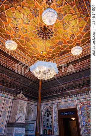 beautiful interior with painted wooden carved ceiling and walls in Museum of Art of Uzbekistan with traditional Uzbek patterns and oriental ornaments in palace in Tashkent 124614804