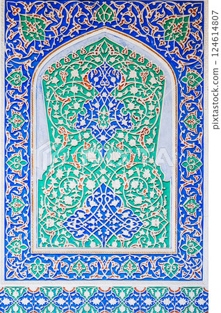 painted carved wooden background with traditional Uzbek ornaments and colorful oriental patterns in Uzbekistan 124614807