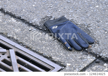 Yokohama cityscape in Japan. Lost glove... after the rain, on the side of the road (crosswalk) where cars are passing... (*not staged) 124614825