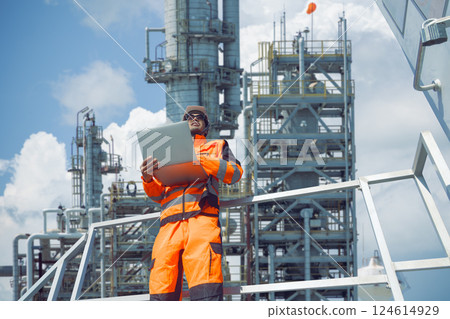 Professional Oil and Gas Petroleum Refinery worker on duty at crude oil distillation tower Asian man 124614929