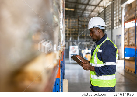 african black professional warehouse worker. stock inventory staff employee working in cargo storage 124614959
