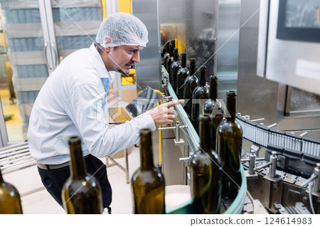 professional engineer technician man service check machine in drink factory for quality standard 124614983