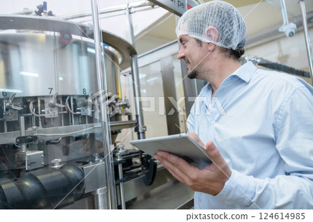 professional engineer technician man service check machine in drink factory for quality standard 124614985