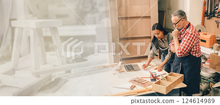 Professional carpenter man working with wood piece design furniture in workshop in wood factory 124614989