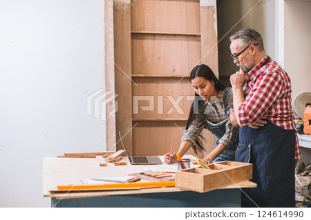 Professional carpenter man working with wood piece design furniture in workshop in wood factory 124614990