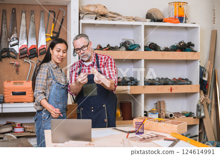 Professional carpenter man working with wood piece design furniture in workshop in wood factory 124614991