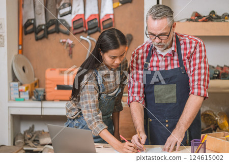 Professional carpenter man working with wood piece design furniture in workshop in wood factory Professional carpenter man working with wood piece design furniture in workshop in wood factory 124615002