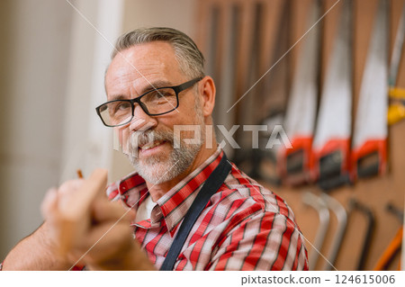 Professional carpenter man working with wood piece design furniture in workshop in wood factory Professional carpenter man working with wood piece design furniture in workshop in wood factory 124615006