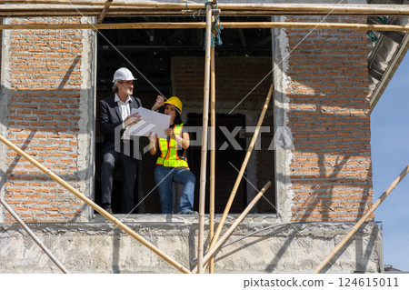Senior Professional Construction engineer talking with women builder worker at construction site. 124615011