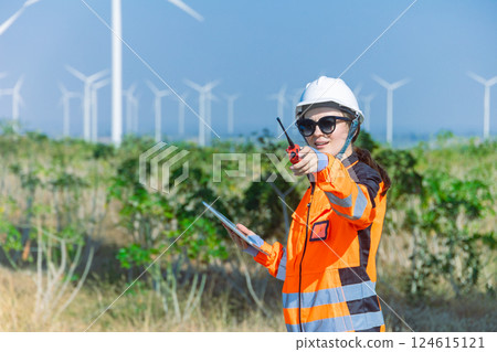 Engineer technician worker checking service maintenance wind turbine clean electricity power station 124615121